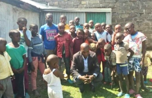 Pastor Enock praying with children, Kenya